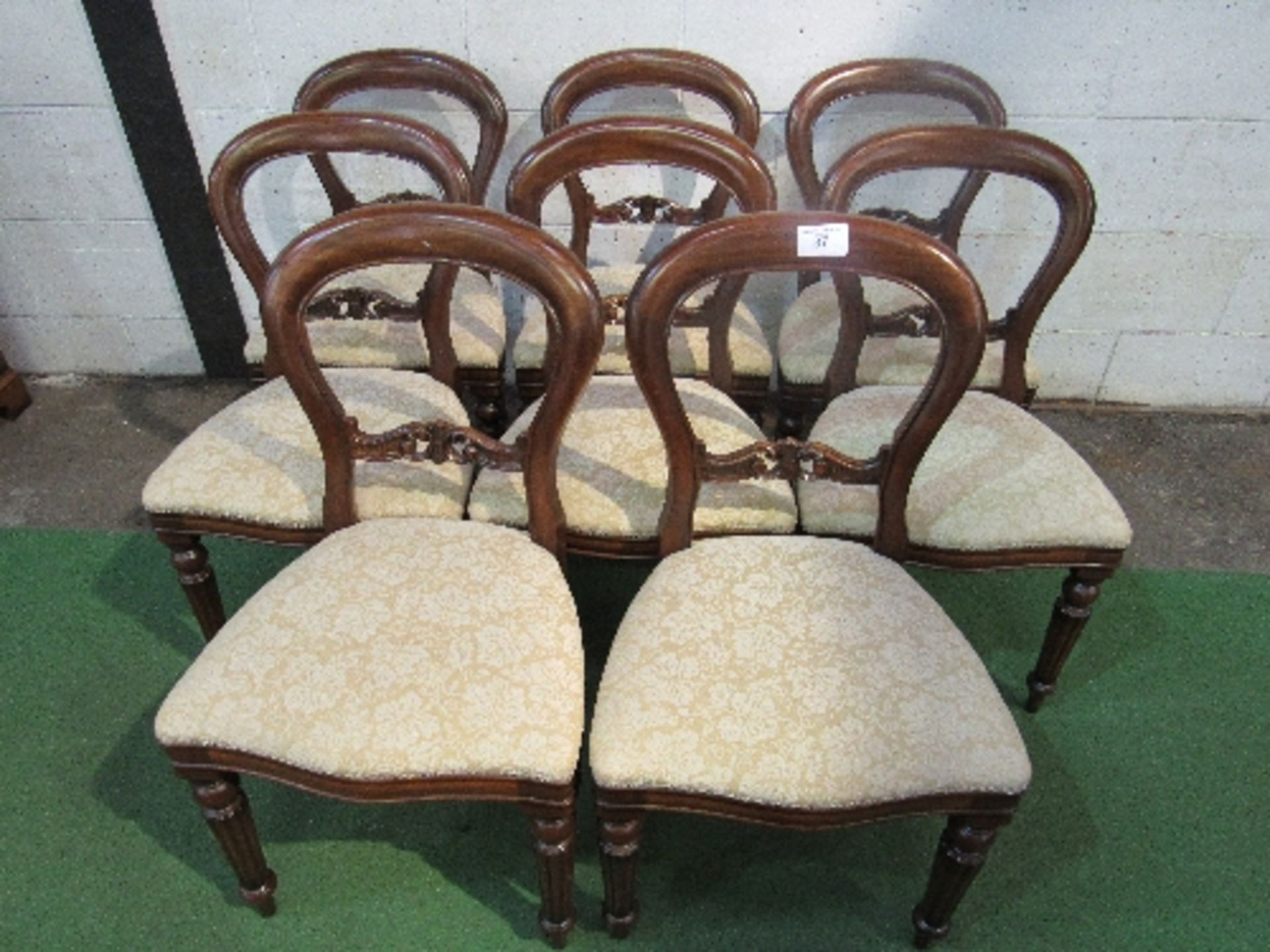 8 mahogany balloon back dining chairs with upholstered seats.