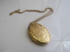 9ct gold engraved locket on 9ct gold chain, length 20inches, weight 19.9gms. Estimate £250-300