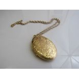 9ct gold engraved locket on 9ct gold chain, length 20inches, weight 19.9gms. Estimate £250-300