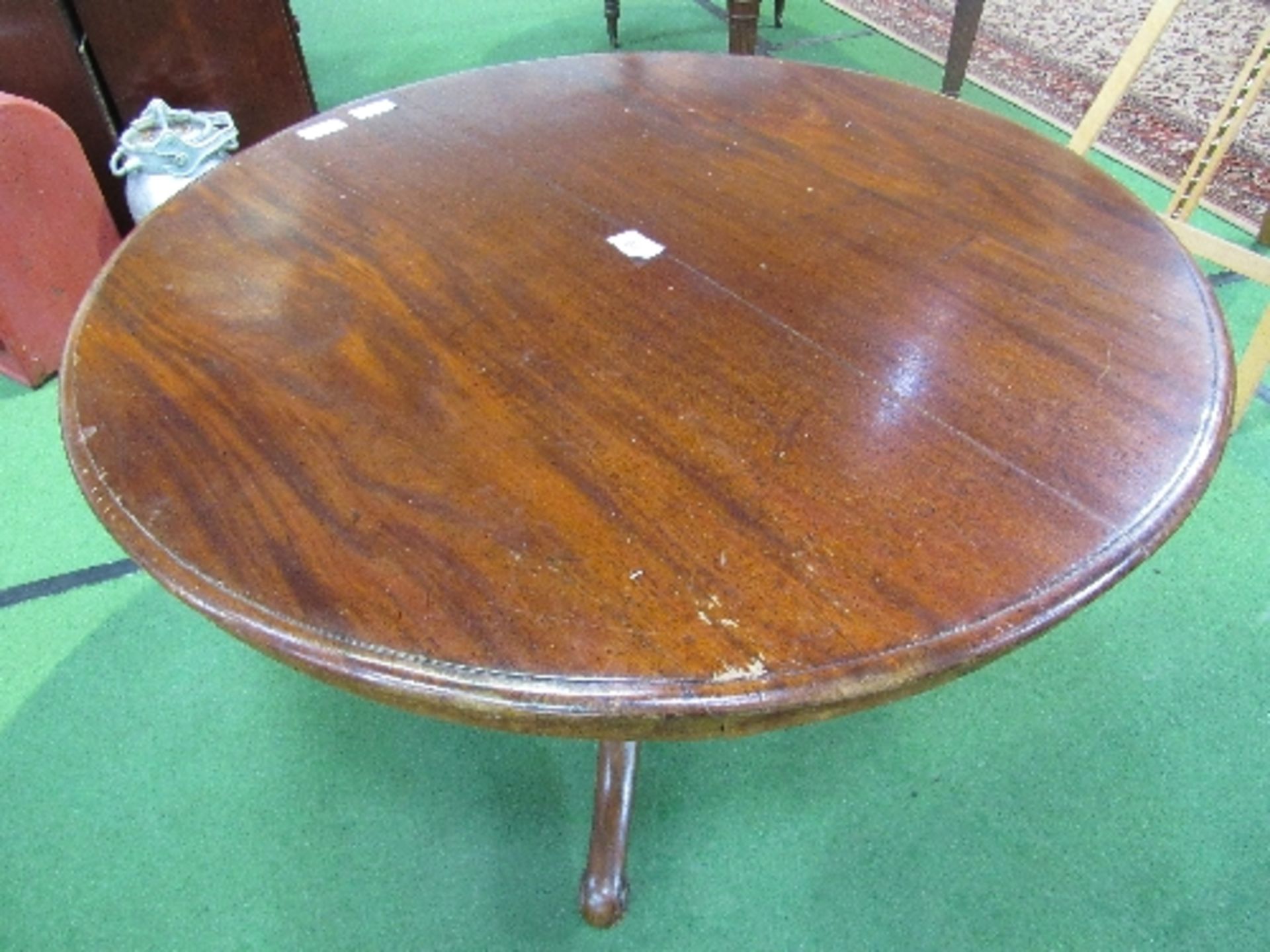 Mahogany circular tilt-top table on heavy turned column to 3 scrolled feet with caster, 122cms - Image 2 of 3