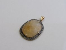 Yellow stone in diamond studded pendant. Estimate £60-80