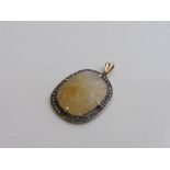 Yellow stone in diamond studded pendant. Estimate £60-80