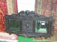 Carved black oak framed double mirror, 67cms x 120cms. Estimate £30-50