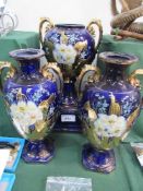 Trio of blue glazed, gold & floral decorated vases.