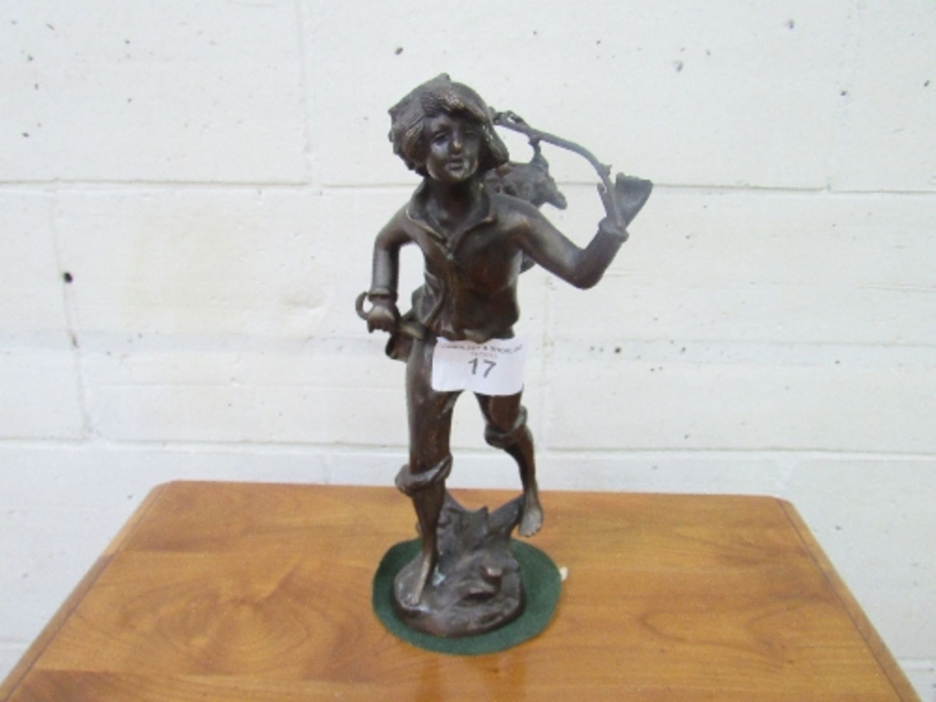 Bronzed figurine of a boy carrying a basket over his shoulder, height 34cms. Estimate £20-40