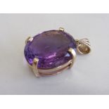 Large oval amethyst set in 9ct gold pendant, weight 10.3gms. Estimate £300-320