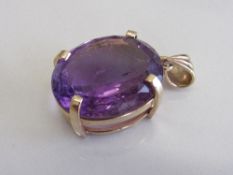 Large oval amethyst set in 9ct gold pendant, weight 10.3gms. Estimate £300-320