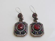 925 silver earring set with central red stones surrounded by other coloured stones. Estimate £50-60