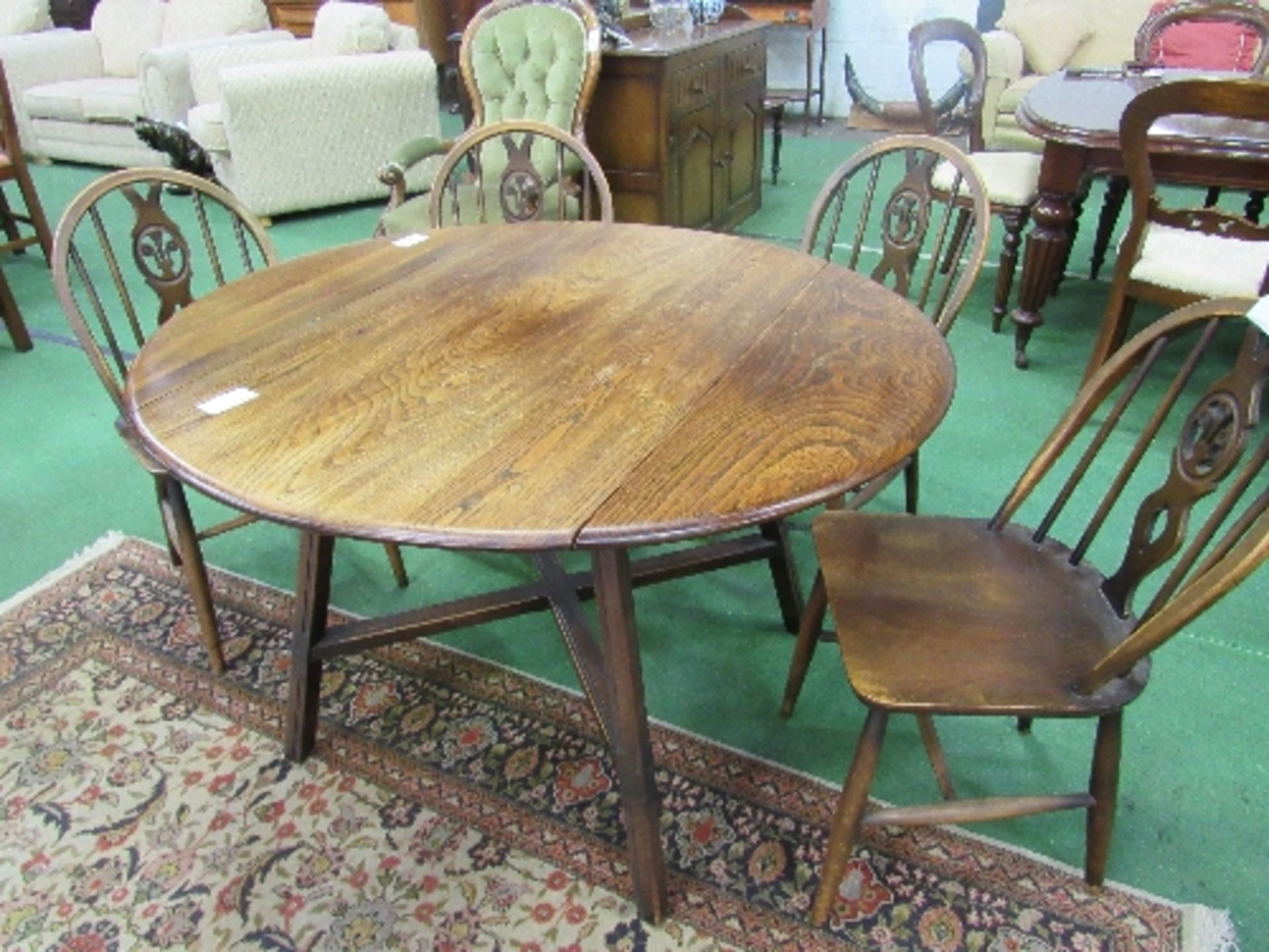 Ercol "Old Colonial" drop-side table with cross stretcher, 107cms diameter (open) x 71cms, with 4