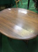 Ercol drop-side gate leg low table, 91 (open) x 106 x 50 cms.  Estimate £40-60