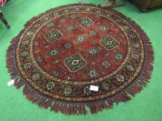 Dark red ground circular rug, diameter 150cms. Estimate £50-80