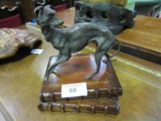 Metal sculptured Lurcher figure standing on wooden plinth of 2 books. Estimate £30-50