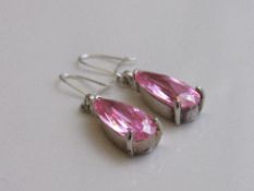 Tear dropped shaped pink stone & silver coloured metal earrings. Estimate £30-40