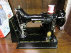 Singer 22LK electric sewing machine in its case.