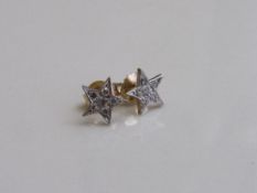 Yellow metal star stud earrings. Estimate £25-35