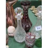 2 cut glass decanters, ruby cut to clear vase Ht 34cms, glass bell and ruby cut to clear lidded pot.