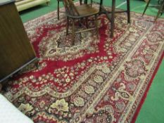 Large red ground rug, 308 x 249cms. Estimate £40-60