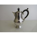 Silver coffee pot with wooden handle, hallmarked Birmingham 1931, weight 11oz, height 17.5cms.