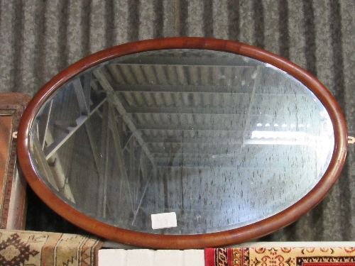 Wood edged inlaid wall mirror together with a mahogany framed oval bevel edged wall mirror. Estimate