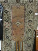 Green ground geometric pattern rug, 211 x 122cms. Estimate £30-40