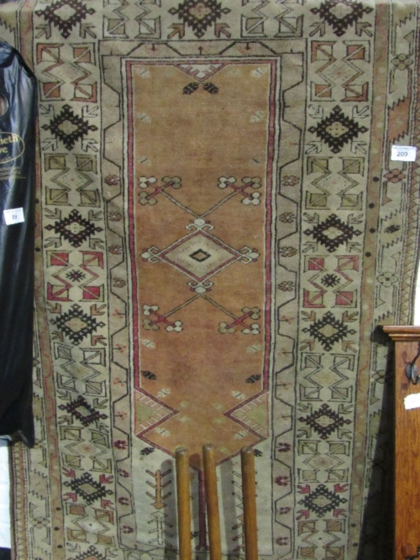 Green ground geometric pattern rug, 211 x 122cms. Estimate £30-40