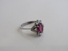 18ct white gold ring with centre ruby & 8 diamond surround, by Stern Jewellers (numbered), size N,