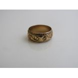 9ct gold band decorated with symbols, size N, weight 4.2gms. Estimate £50-60