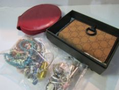 New Gucci purse in box; 24 silver charms/pendants & a bag of costume jewellery. Estimate £20-40