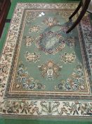 Green ground rug, 176 x 126cms. Estimate £25-35