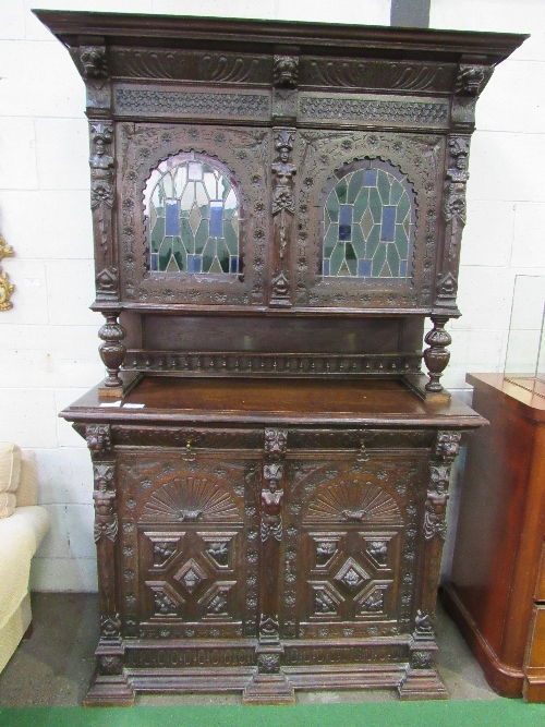 Large ornately carved continental dresser/cabinet with 2 stained glass fronted doors to cabinet over