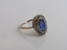 9ct gold ring set with an oval shaped sapphire, surrounded by white sapphires, size P, weight 2.