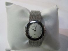 Lady's Skagen stainless steel watch, white dial with gemstone marks in original box. Est 20-30