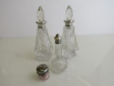 Pair of cut glass silver rim bottles with stoppers, London 1927 (1 stopper a/f); small silver lidded