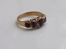 Yellow metal ring set with 5 garnets, size L. Estimate £70-100