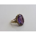 9ct gold ring set with a large oval Alexandrite stone, 1.7cms x 1.3cms, size N½, weight 7.8 gms.