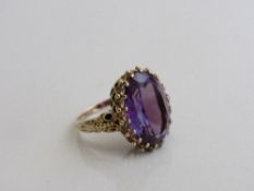 9ct gold ring set with a large oval Alexandrite stone, 1.7cms x 1.3cms, size N½, weight 7.8 gms.