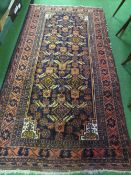 Dark orange & dark blue ground rug, 200 x 105cms. Estimate £40-50