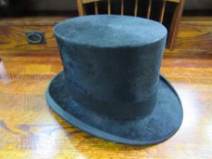 Black silk top hat, approx internal measurements 21cm x 16cm, Estimate £100-120