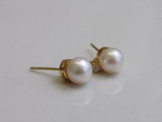 Pair of pearl & diamond stud earrings. Estimate £150-200