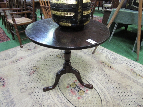 Oak circular tilt-top pedestal table to 3 legs on pad feet, diameter 73cms, height 70cms.