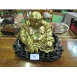 Brass Buddha on carved wooden base, height 32cms, width 40cms. Estimate £100-120