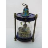 Novelty manual mantel clock housed in glass with fish swimming in time to the movement. Estimate £
