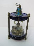 Novelty manual mantel clock housed in glass with fish swimming in time to the movement. Estimate £