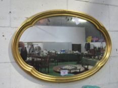 Gilt framed shaped oval wall mirror, 61 x 92cms. Estimate £20-30