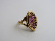 18ct gold oval shaped ring with a setting of red stones, weight 5.1gms size L. Est £130-150