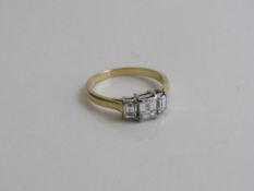 18ct gold & 3 stone diamond ring. Diamonds, emerald cut 1ct total, colour G, clarity VS. Size N 1/2.