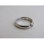 Platinum band with white stone, size M 1/2. Estimate £70-80