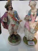 A pair of Continental porcelain figures, male & female, in 17th century costume, male figure has