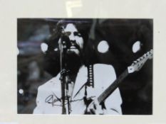Framed & glazed autographed black & white photo of George Harrison. Estimate £25-35