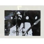 Framed & glazed autographed black & white photo of George Harrison. Estimate £25-35